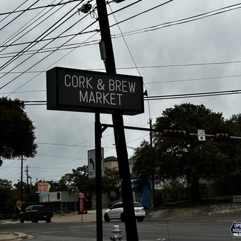 RAS MODERN INDIAN - a street sign for cork and brew market - Indian Near Me - Austin, Texas RAS MODERN INDIAN - a street sign for cork and brew market - Indian Near Me - Austin, Texas