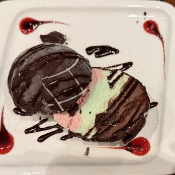 Caprizza Ristorante - Tartufo ice cream inside a dome-shaped chocolate shell, a dessert hailed from Calabria Italy - Italian Near Me - San Francisco, California