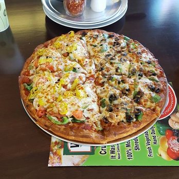 Wana Pizza - a large pizza on a table - Pizza Near Me - La Porte, Indiana Wana Pizza - a large pizza on a table - Pizza Near Me - La Porte, Indiana