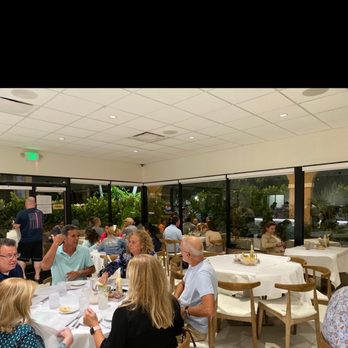 Madrono Restaurant - a group of people sitting around a table - Latin American Near Me - Miami, Florida Madrono Restaurant - a group of people sitting around a table - Latin American Near Me - Miami, Florida