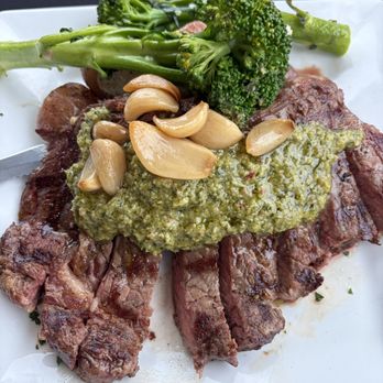 La Baia - 12 oz steak with potatoes, broccolini and roasted garlic - Italian Near Me - Waldport, Oregon La Baia - 12 oz steak with potatoes, broccolini and roasted garlic - Italian Near Me - Waldport, Oregon