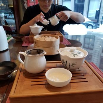 Ming Tao Xuan - a man pouring tea into a cup - Tea Rooms Near Me - Montreal, Quebec Ming Tao Xuan - a man pouring tea into a cup - Tea Rooms Near Me - Montreal, Quebec
