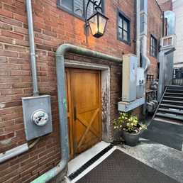 Entrance - no signage. The door with the light over it Entrance - no signage. The door with the light over it