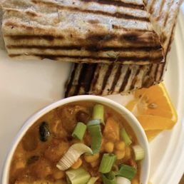 a bowl of soup and a grilled cheese sandwich