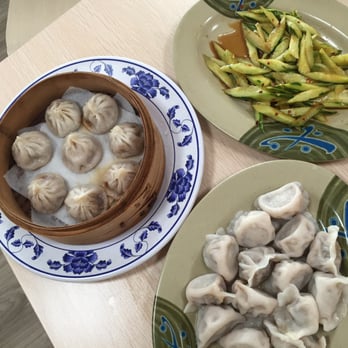 New Lan Zhou Noodle - Shanghai soup dumplings in bamboo steamer, chives dumplings and pickled cucumber. - Chinese Near Me - Chamblee, Georgia