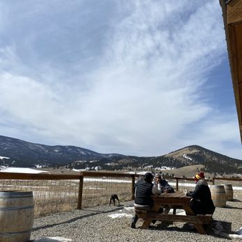 Comanche Creek Brewery - two people sitting at a picnic table - Breweries Near Me - Eagle Nest, New Mexico