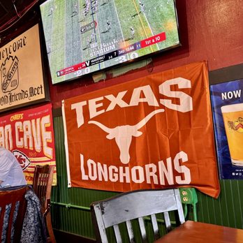 The Tavern - a man sitting at a table with a glass of beer - Sports Bars Near Me - Austin, Texas The Tavern - a man sitting at a table with a glass of beer - Sports Bars Near Me - Austin, Texas