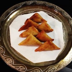 Marrakesh Express - Savory saffron braised chicken paired with honey sweetened almond butter - Briouate "bastilla bites"