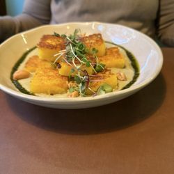 Casa Raw - Fried Brazilian potato (mandioquinha) gnocchi with pesto. Delicious dish