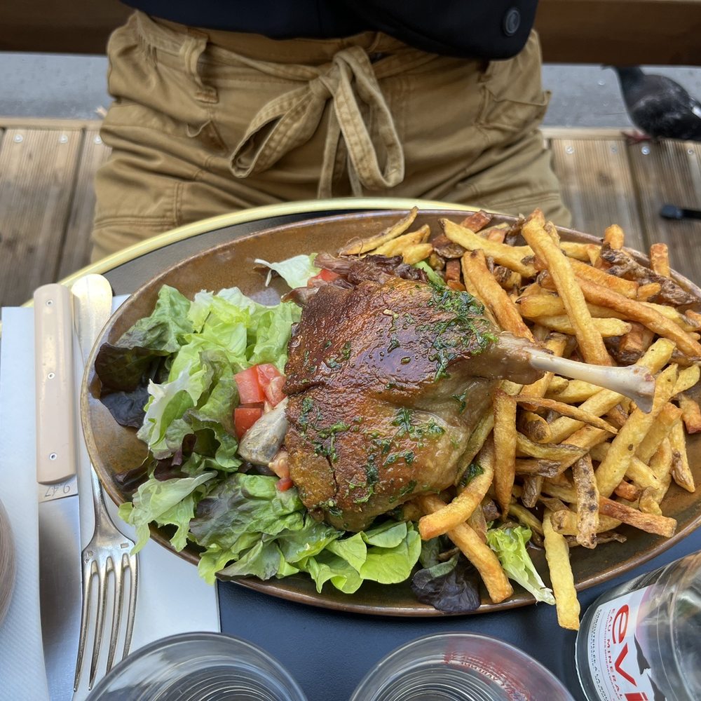 Duck confit with fries and salad. Duck confit with fries and salad.