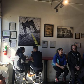 Wholy Bagel - Lots of NYC art on the wall, and some bar stools to sit at. - Bagels Near Me - Austin, Texas