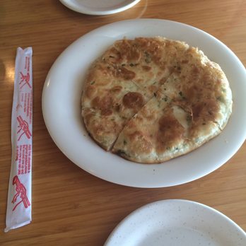 Golden Dumpling House - Pan fried onion cake was a lot bigger than expected for $1.25. Chopsticks for size comparison. - Chinese Near Me - Houston, Texas Golden Dumpling House - Pan fried onion cake was a lot bigger than expected for $1.25. Chopsticks for size comparison. - Chinese Near Me - Houston, Texas
