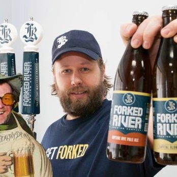 Forked River Brewing Company - a man holding a bottle of beer - Breweries Near Me - London, Ontario