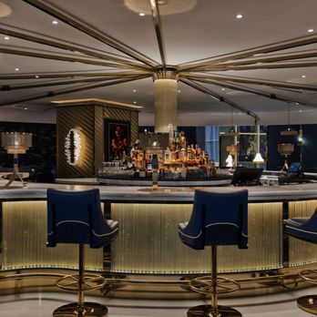 Collins - a bar with a circular counter and blue chairs - Cocktail Bars Near Me - Las Vegas, Nevada