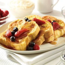 Sunset Grill - Three slices of thick French toast topped with pure maple syrup and fresh fruit.