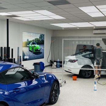 Midnight Tinting - Inside the work area with 3 guys working on the car. - Car Window Tinting Near Me - Honolulu, Hawaii