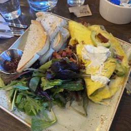 My bacon, avacado omelet with the menu serving of greens and toast