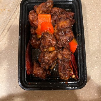 Hunan Taste - a black plastic container filled with meat and vegetables - Chinese Near Me - Montclair, New Jersey