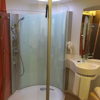 Nomad Paris Roissy - Shower in the room. There is a shower curtain that covers it though - Hotels Near Me - Le Mesnil-Amelot, 77