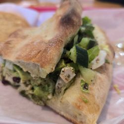 CHICKN PESTO! Chz, Pesto, Olive Tapenade, Lettuce Aioli (Roasted Garlic, & Red Pepper), Tomatoes, Cucumbers, Dried Cranberries, Avocado