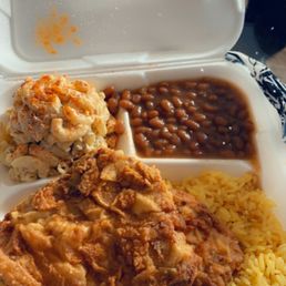 Fried pork chops, yellow rice,baked beans and tuna salad.