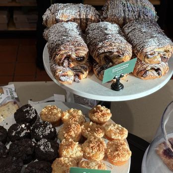 Panera Bread - Macaroons and Chocolate Croissants!!! - A selection of chocolate croissants, cookies, and other baked goods arranged on a table at a bakery or cafe. - Sandwiches Near Me - Columbia, Maryland