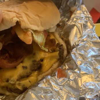 MrBeast Burger - a hand holding a hamburger - Food Delivery Services Near Me