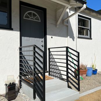 RCC Landscape - a white house with a black door - Masonry/Concrete Near Me RCC Landscape - a white house with a black door - Masonry/Concrete Near Me