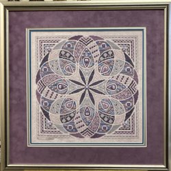 Karl’s Custom Framing - Needlepoint matted in blue, silver and a sued finish lavender and a classic silver frame.
