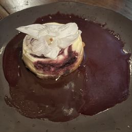 Huckleberry cheesecake with chocolate and huckleberry sauces.