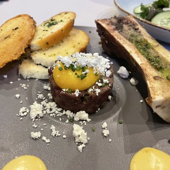 Riverhorse On Main - Buffalo tartare w/ egg yolk, capers, dijonnaise sauce, and served w/ herb baguettes and bone marrow - New American Near Me - Park City, Utah Riverhorse On Main - Buffalo tartare w/ egg yolk, capers, dijonnaise sauce, and served w/ herb baguettes and bone marrow - New American Near Me - Park City, Utah
