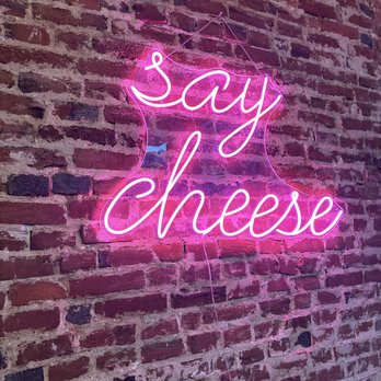 Philly Cheese School - a neon sign on a brick wall - Cheese Shops Near Me - Philadelphia, Pennsylvania