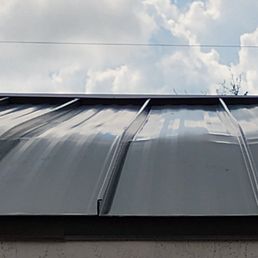 Metal roof with dents and creases