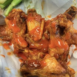 a plate of chicken wings and celery