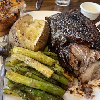 Brewsters Bar & Grill - Half rack baby back ribs with steamed asparagus & a baked potato. - New American Near Me - Galt, California
