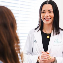 Coastal Health & Medical Spa - Dr. Olivia consulting with a patient about ZO Skin Health products offered at Coastal Health & Medeical Spa.