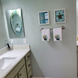 a bathroom with a sink, toilet, and mirror