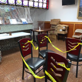 China Wok - a restaurant with tables and chairs taped with yellow tape - Chinese Near Me - Saint Petersburg, Florida
