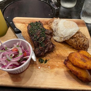 Inka Grill  - Strip steak, rice and beans with egg, pickled onions, fried plantains. - Peruvian Near Me - Roanoke, Virginia
