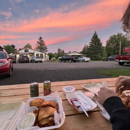 a woman eating at a picnic table