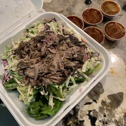 a salad in a styrofoam container