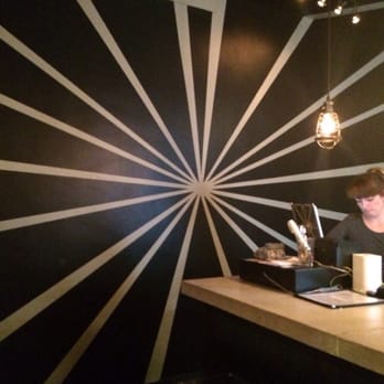Ossington Stop - a woman working on her laptop - Pubs Near Me - Toronto, Ontario