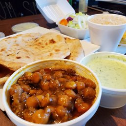 Chickpeas, rice, salad, and naan Chickpeas, rice, salad, and naan