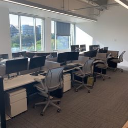 Cube World USA - Recent Install in Austin for 11 stations with Sit-On It desks, pedestals, dual monitor arms, and chairs.
