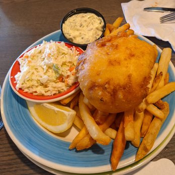 Atlantic Grille - Fish and chips - A seafood dish featuring fried fish, French fries, coleslaw, tartar sauce, and a lemon wedge served on a colorful plate. - Breakfast & Brunch Near Me - Middletown, Rhode Island