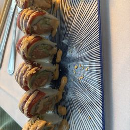 Dragon roll, which includes salmon and Tuna Dragon Roll Dragon roll, which includes salmon and Tuna Dragon Roll