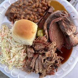 Pulled pork, brisket, coleslaw, and baked beans. Pulled pork, brisket, coleslaw, and baked beans.