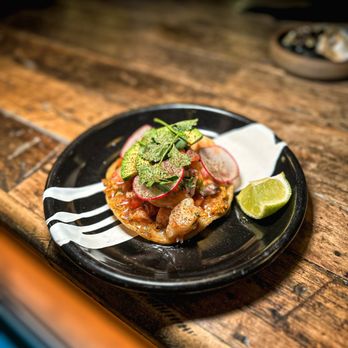 Diego - a plate of food on a wooden table - Cocktail Bars Near Me - Chicago, Illinois Diego - a plate of food on a wooden table - Cocktail Bars Near Me - Chicago, Illinois