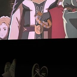 Dark picture taken during a preview, but shows the view from a cuddle couch in the front row!
