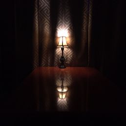 a lamp on a table in the dark